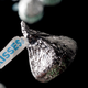 Silver Hershey Kiss on a black background